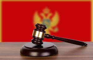 Wooden gavel and flag of Montenegro