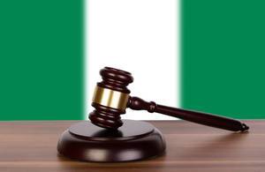 Wooden gavel and flag of Nigeria