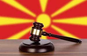 Wooden gavel and flag of North Macedonia