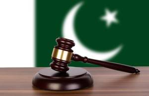 Wooden gavel and flag of Pakistan