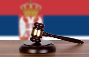 Wooden gavel and flag of Serbia