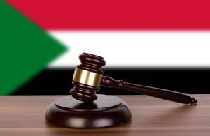 Wooden gavel and flag of Sudan