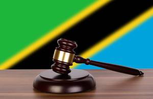 Wooden gavel and flag of Tanzania