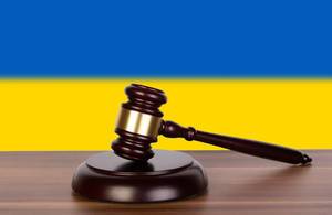 Wooden gavel and flag of Ukraine