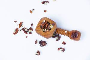 Wooden nutcracker with nuts on white background