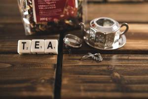 Word TEA with tea dispenser and tea bag