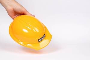 Workers hand holding safety helmet