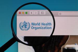 World Health Organization logo under magnifying glass