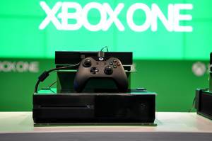 Xbox One with Controller with the green Logo in the background