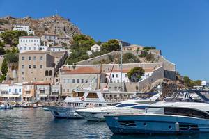 Yachts and ferries in the port of the saronic and car-free island Hydra in Greece