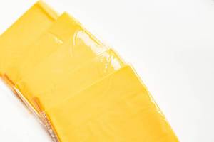 Yellow american sandwich cheese slices on white background