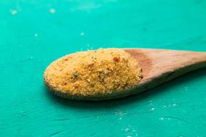 Yellow Culinary Spice on Wooden Spoon