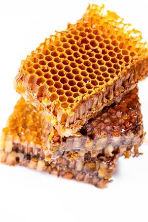 Yellow honeycomb slices on top of each other in white background