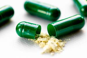 Yellow powder with green capsules. The concept of drug treatment