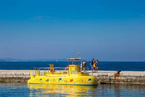 Yellow submarine with people on pier in Zadar, Croatia