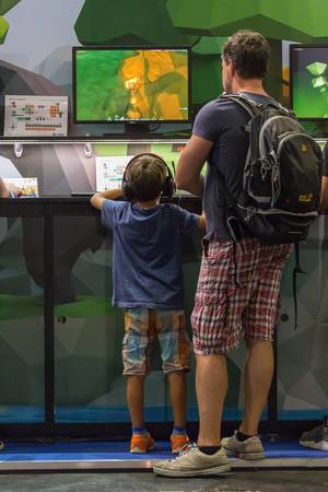 Young gamer and his dad gaming at Gamescom 2018