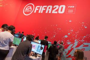 Young gamers play FIFA 20 from EA Sports at the German games fair Gamescom