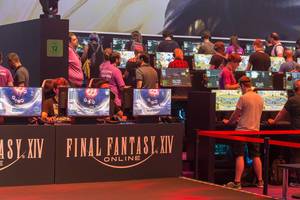 Young games fair visitors play the multiplayer online role-playing game Final Fantasy XIV Shadowbringers