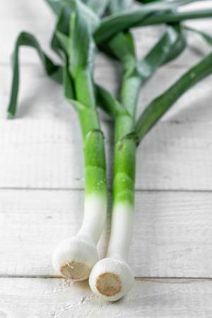 Young green garlic on a wooden background