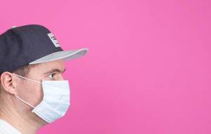 Young man with medical flu mask