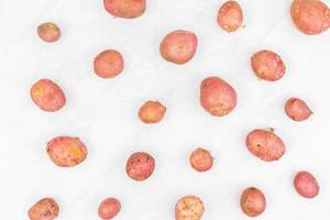 Young Red Potatoes on the grey marble table