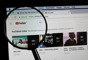 Youtube logo on a computer screen with a magnifying glass